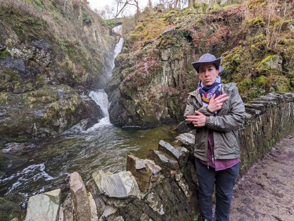 Woman standing in front of waterall in the UK